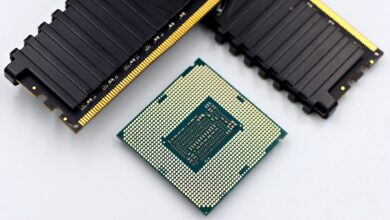Two DDR5 RAM kits side by side on a dark surface showing heat spreaders and RGB lighting