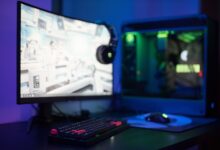 A high-end gaming PC setup with RGB lighting, representing mid-range GPU comparisons at 1440p